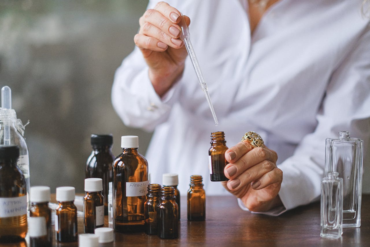 Mastering the First Impression: Your intriguing post title goes here Close-up of hands handling amber glass bottles during an aromatherapy session.