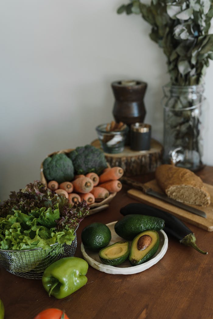 The Art of Drawing Readers In: Your attractive post title goes here A rustic still life of fresh vegetables, avocados, and bread on a wooden table.