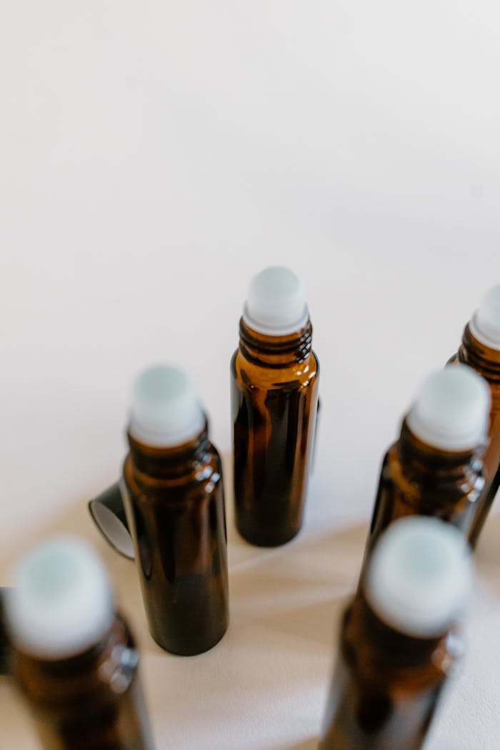 A detailed view of several empty amber glass roller bottles arranged in a pattern.