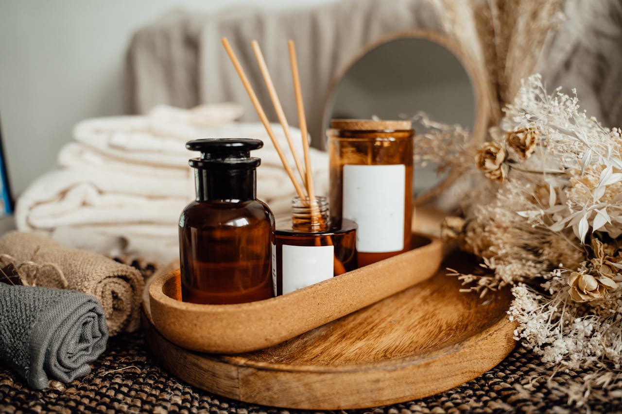 why-choose-us A tranquil spa setup featuring aromatherapy oils, candles, and dried flowers for relaxation.