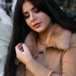 Glamorous portrait of a brunette woman with long hair, elegantly dressed in İstanbul.