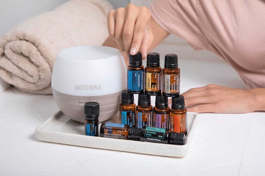 doTERRA essencial oils for hollistic treatment and well being A tray with essential oils, a diffuser, and a towel for a relaxing spa ambiance.